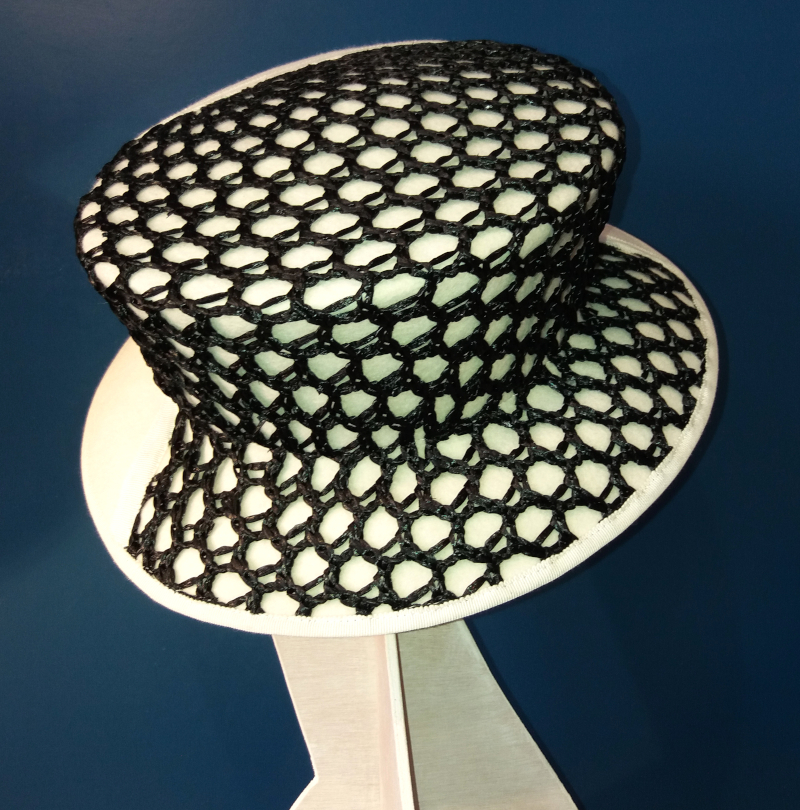 Chapeau de forme amazone beige clair surmonté d'une résille noire